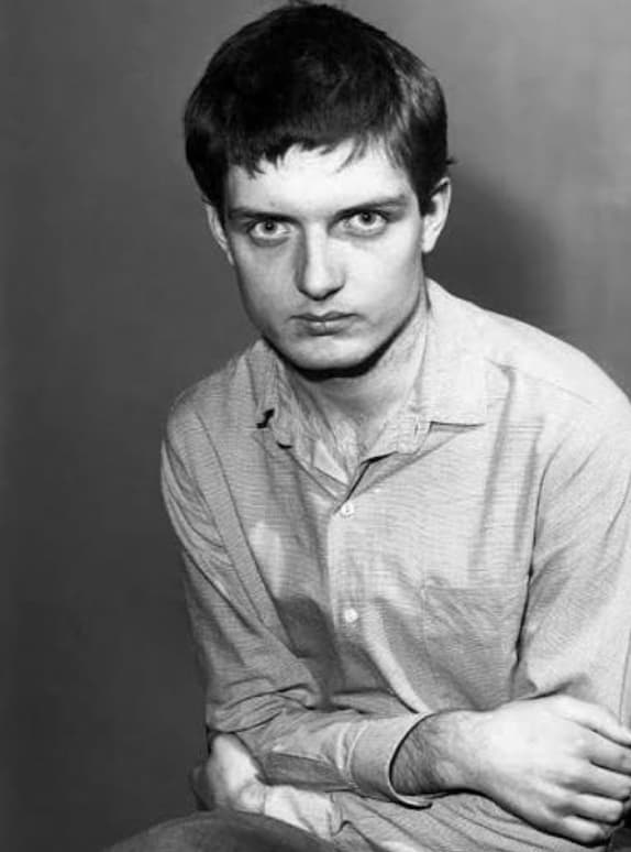 Ian Curtis, studio portrait, arms crossed